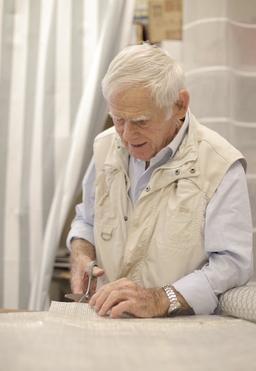 Photo of Man Cutting Using Scissors