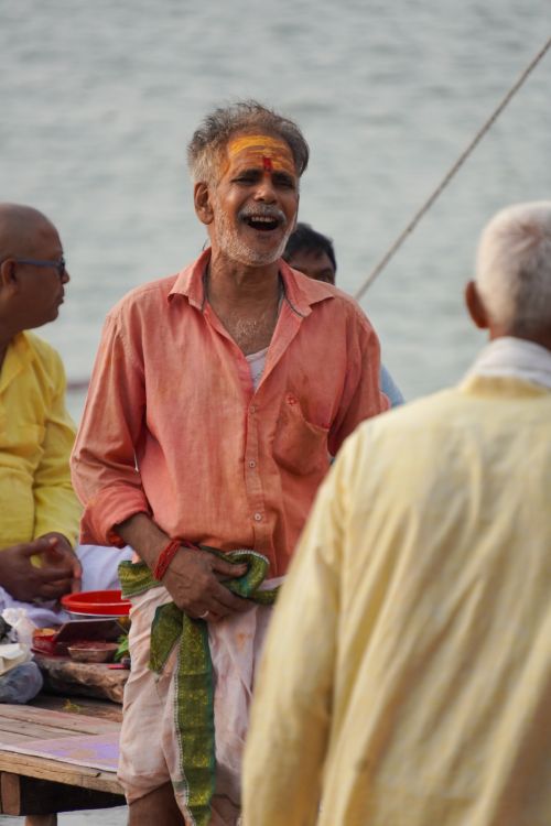 Free Elderly men in Varanasi share a moment of joy and laughter by the Ganges River. Stock Photo