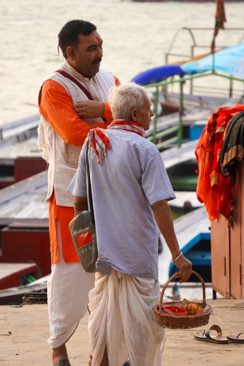 Free A candid scene depicting two men conversing at the ghats in Varanasi, India. Stock Photo