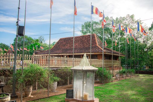 Discover the historic Seruwawila Buddhist Temple in Eastern Sri Lanka with vibrant flags and traditional architecture.