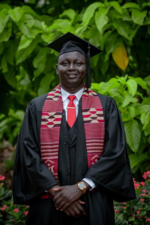 Free Proud graduate in cap and gown at outdoor ceremony, Bor, South Sudan. Stock Photo