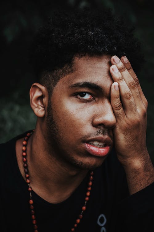 Free Man in Black Top Covering His Face Stock Photo