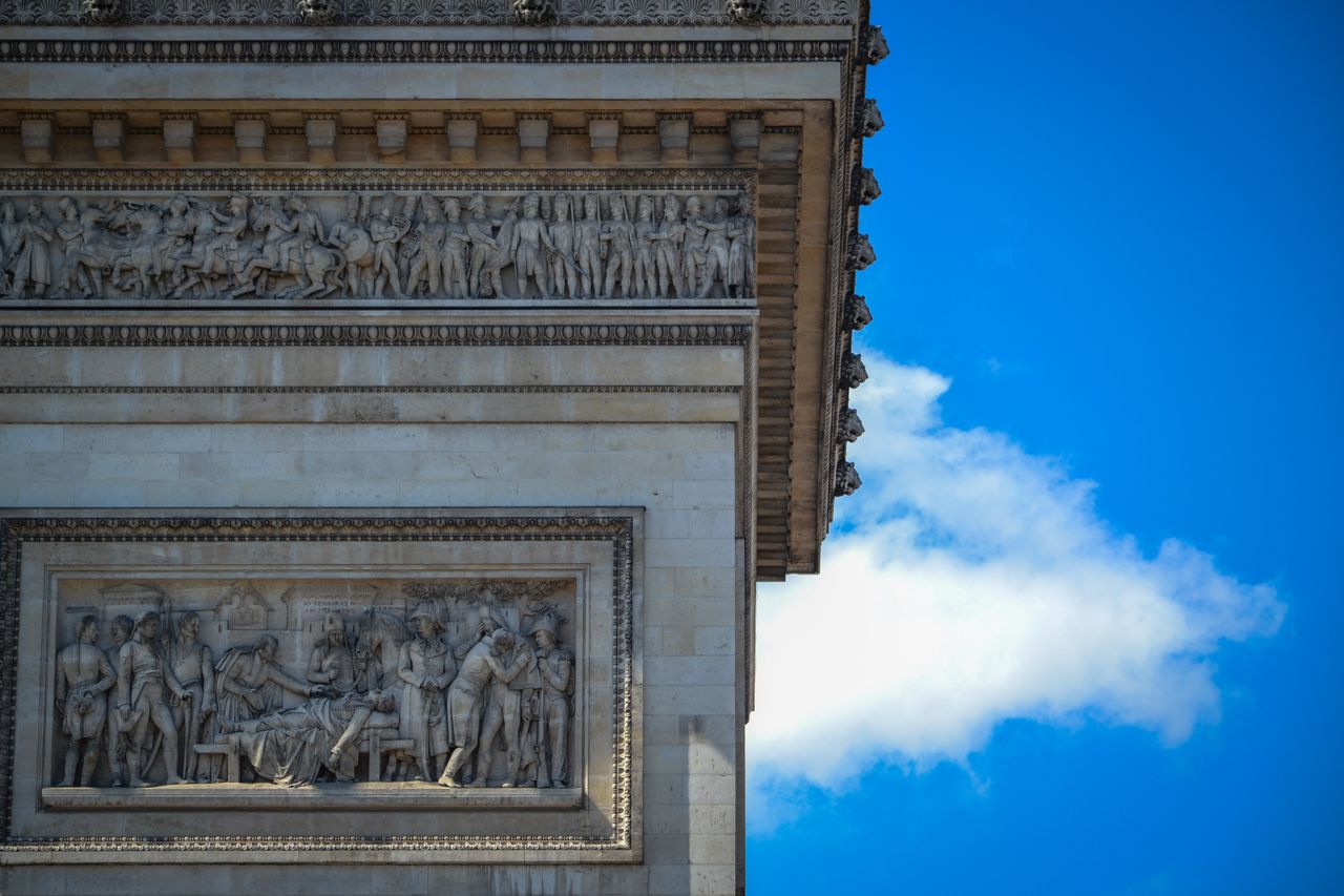 detail shot of the arc de triomphe showcasing its intricate sculptures