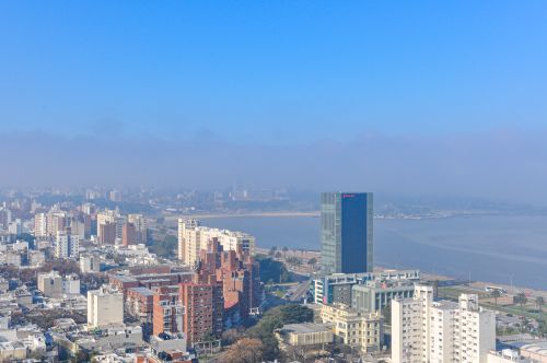Free Aerial view of Montevideo cityscape and coastline under a clear blue sky. Stock Photo