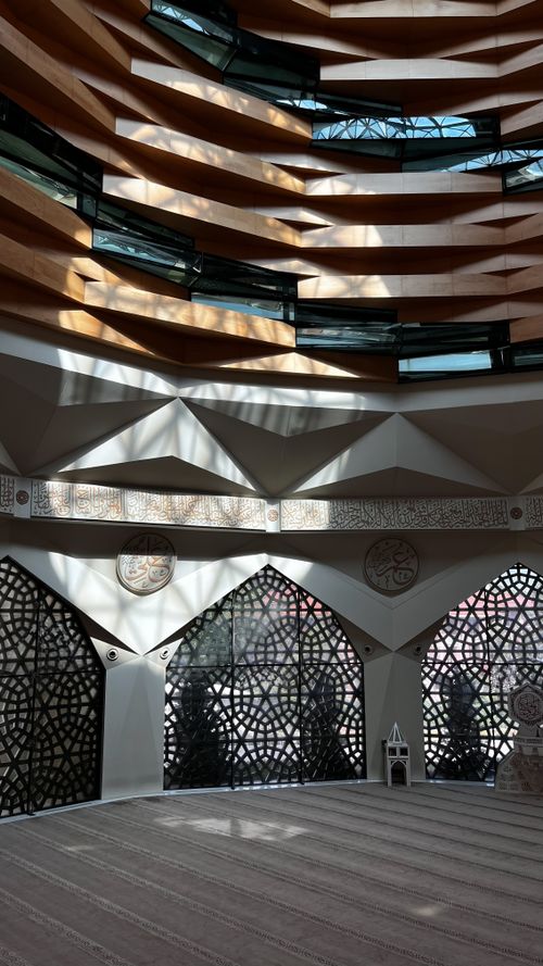 Free A beautifully lit interior showcasing intricate Islamic architectural design with geometric patterns. Stock Photo