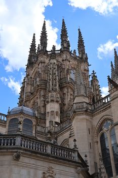 Stunning view of Burgos Cathedral's intricate Gothic spires against a blue sky.