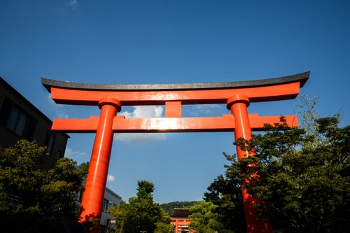 Free Breathtaking view of a traditional red Torii gate under blue skies in Kyoto, Japan. Stock Photo
