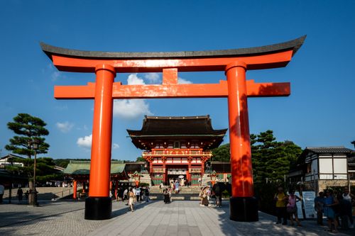 Free View of the iconic Torii gate leading to Fushimi Inari Shrine in Kyoto, Japan, a popular tourist attraction. Stock Photo