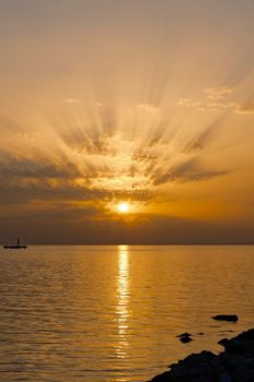A breathtaking sunset over the ocean with radiant clouds and serene reflections.
