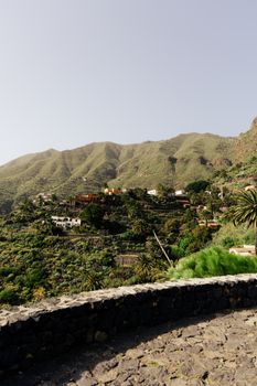 Panoramic view of the picturesque Masca village surrounded by lush green mountains in Tenerife, Spain.