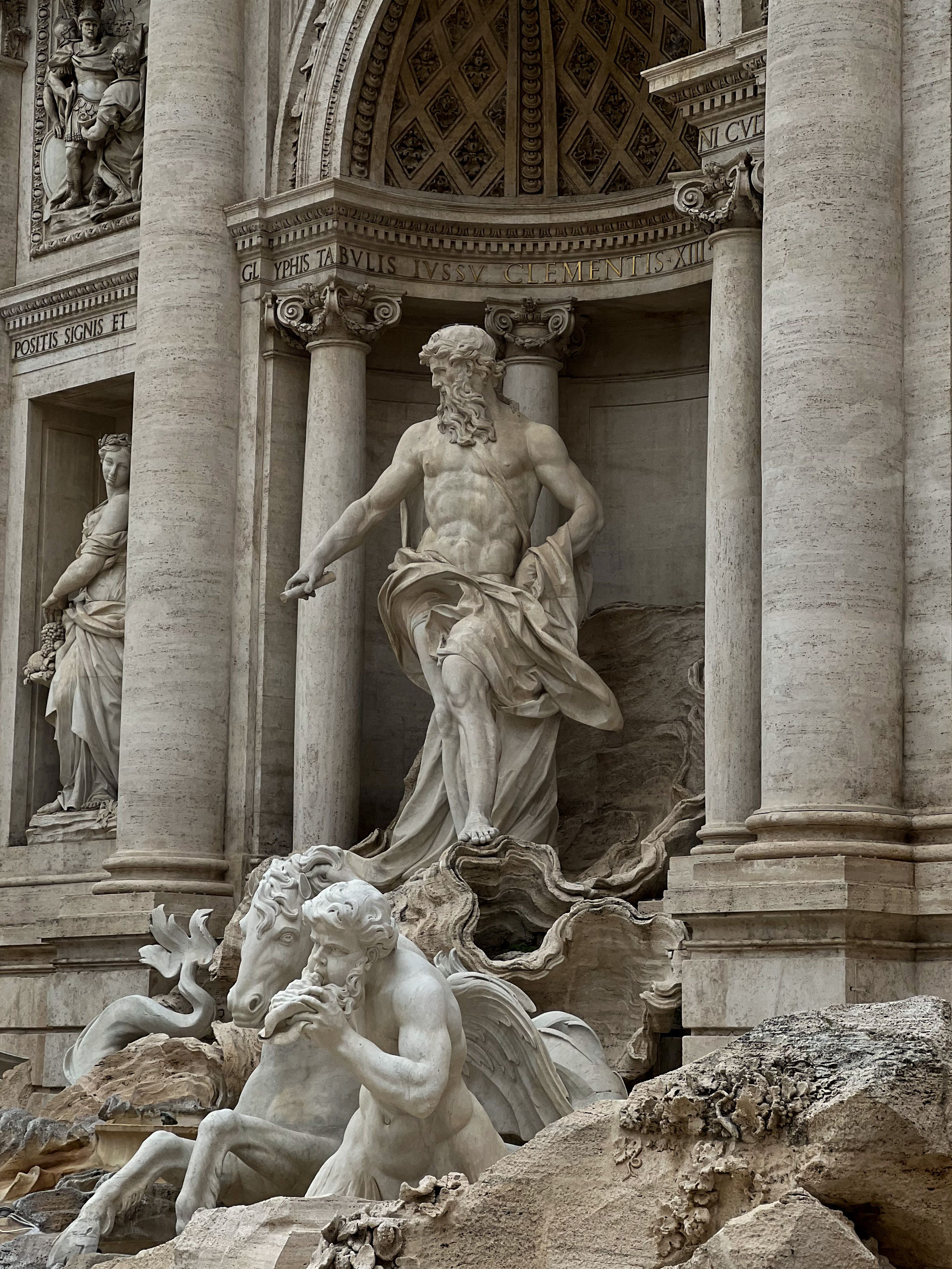 Intricate sculptures at Trevi Fountain, showcasing classical Renaissance art in Rome.