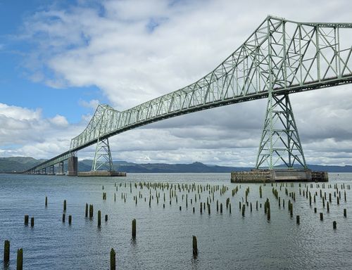 Free View of the Astoria-Megler Bridge spanning the Columbia River with cloudy sky. Stock Photo