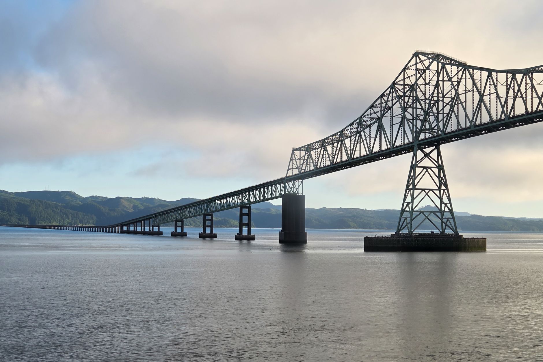 Striking view of Astoria-Megler Bridge crossing the Columbia River under a cloudy sky.