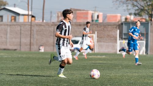 Free Teenage soccer players in action during a match on an outdoor field under daylight. Stock Photo