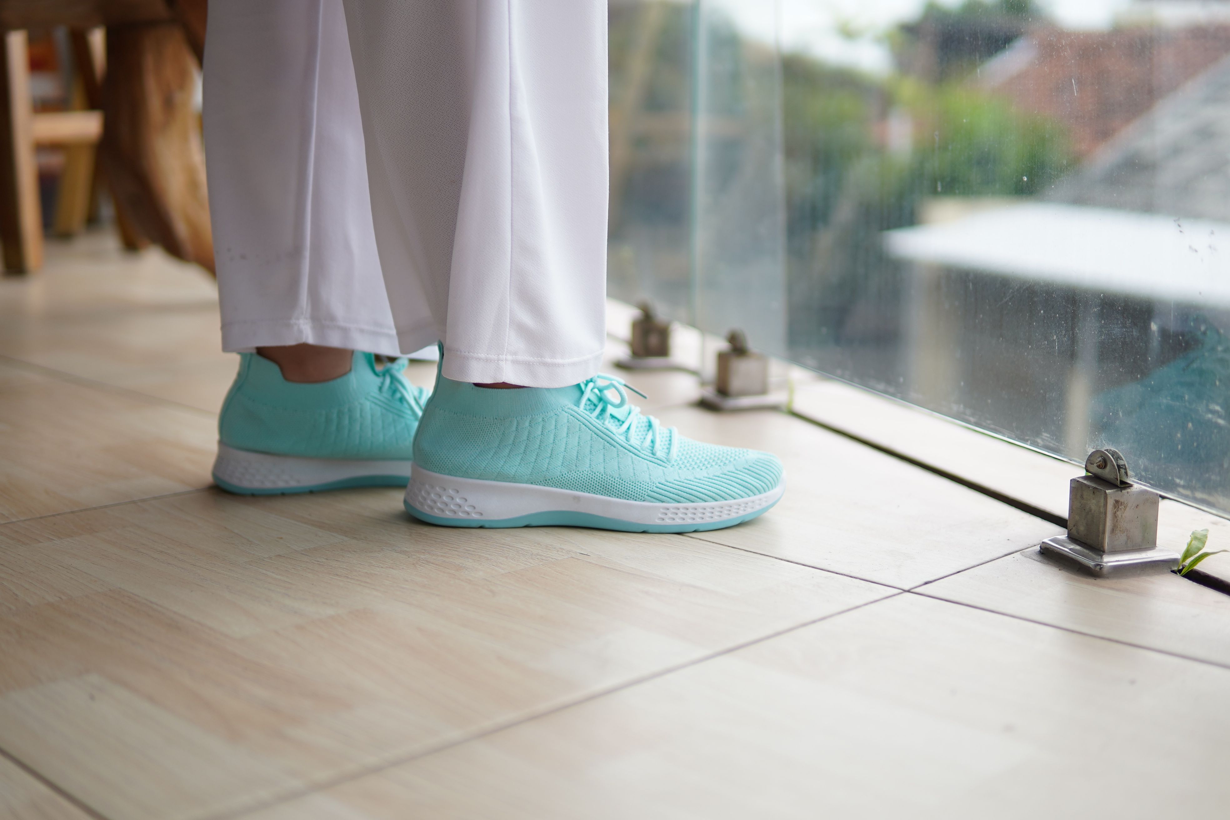 Stylish Turquoise Sneakers on Modern Balcony