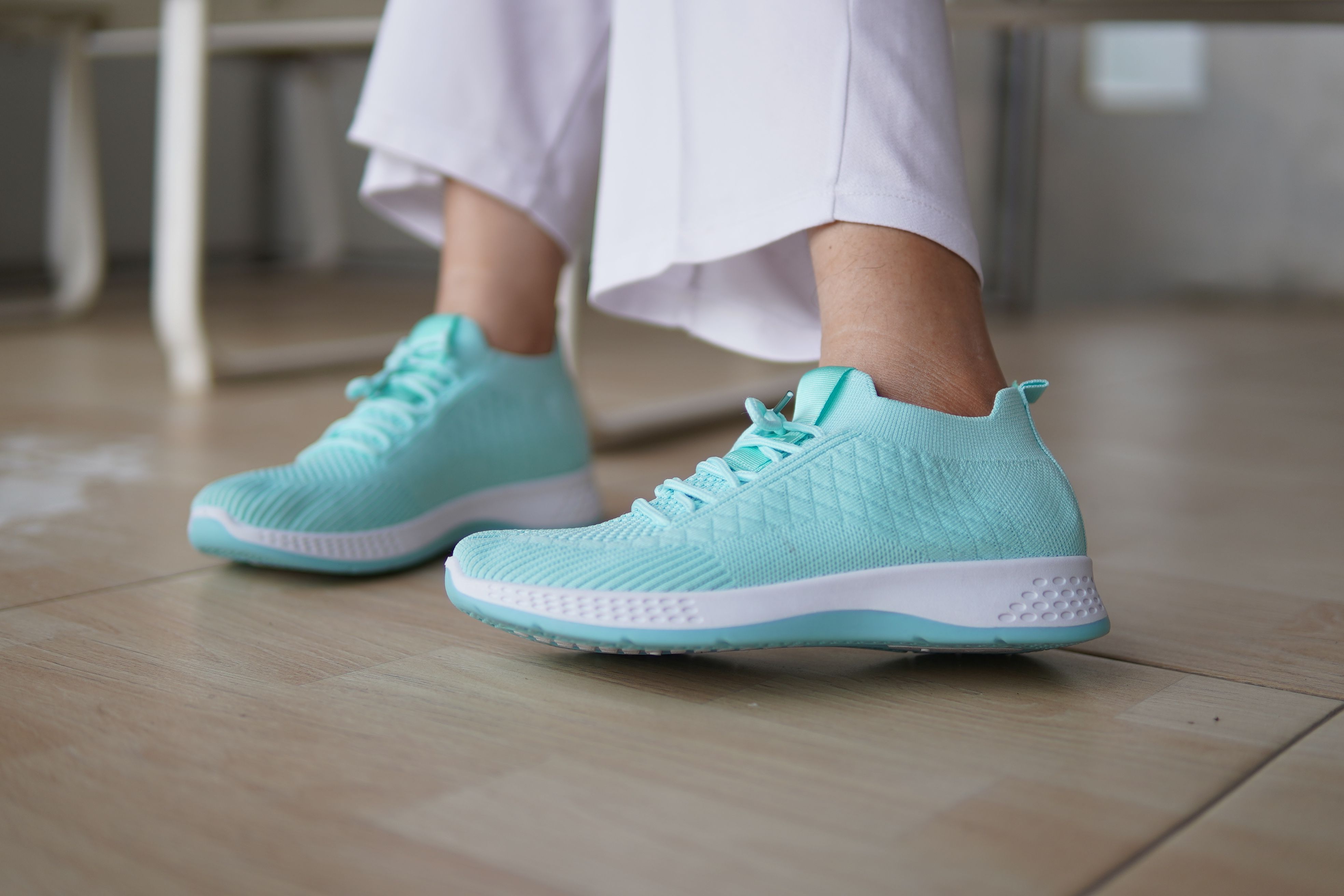 Stylish Mint Green Sneakers on Wooden Floor