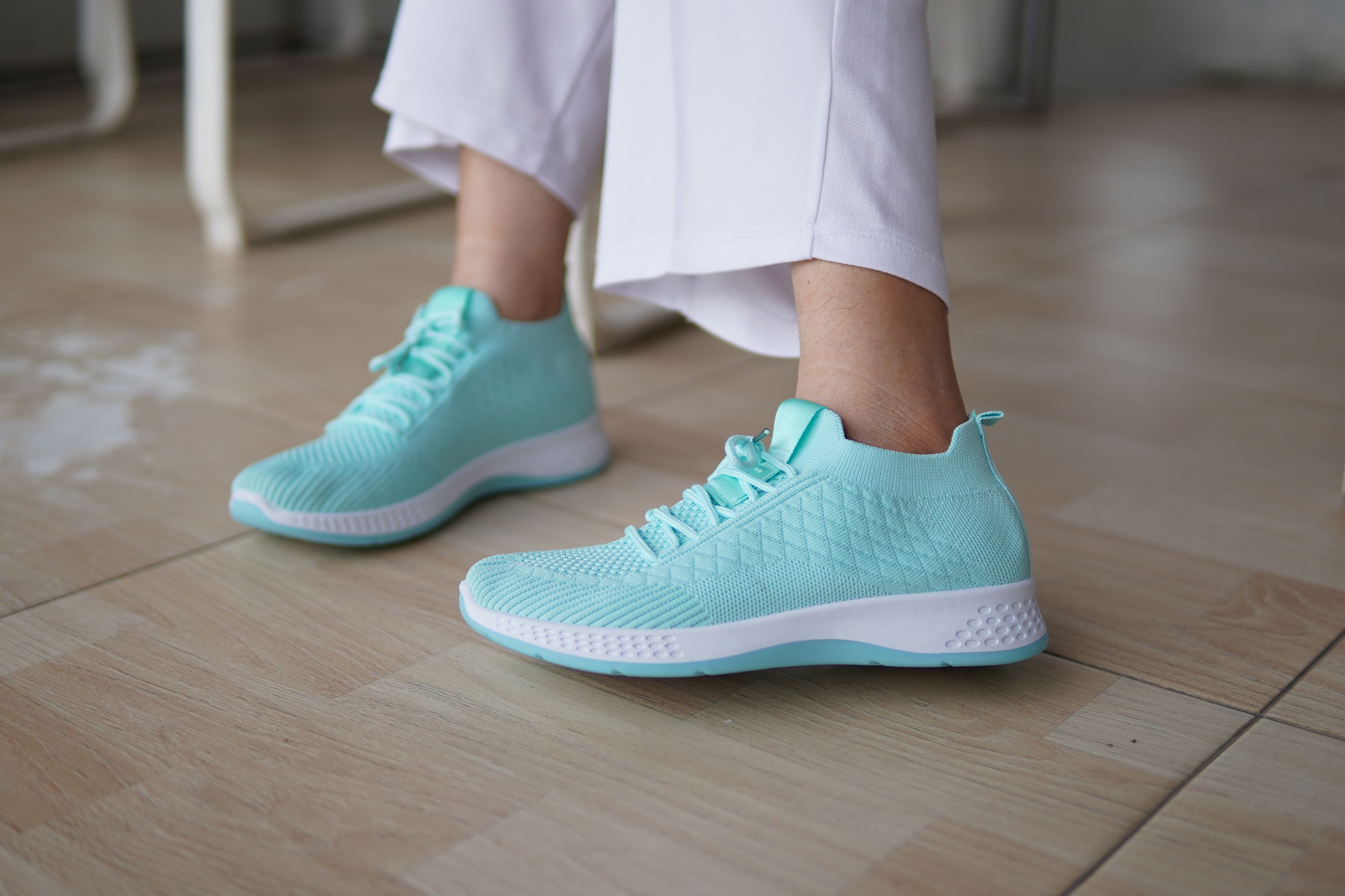 Stylish Mint Green Sneakers on Wooden Floor