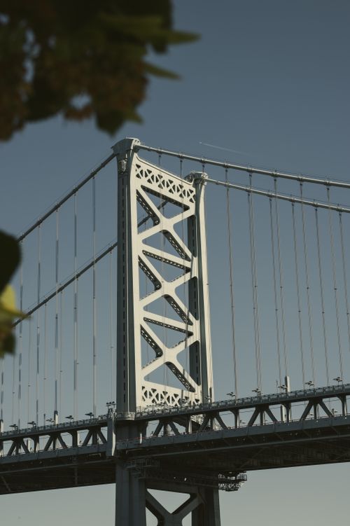 Free Close-up of a suspension bridge tower against a clear sky, ideal for travel and architecture themes. Stock Photo