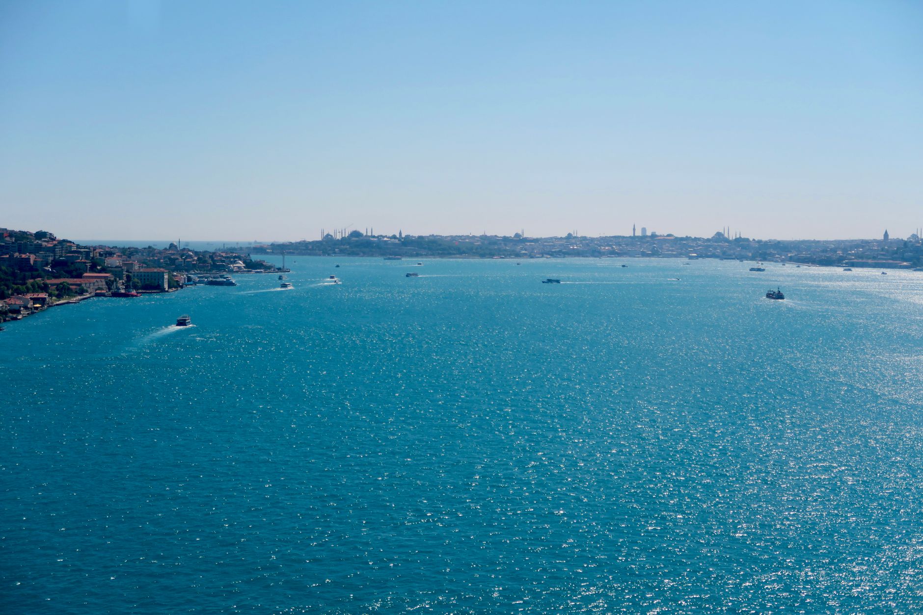 A beautiful view of the Bosphorus Strait with boats in Istanbul on a sunny day.