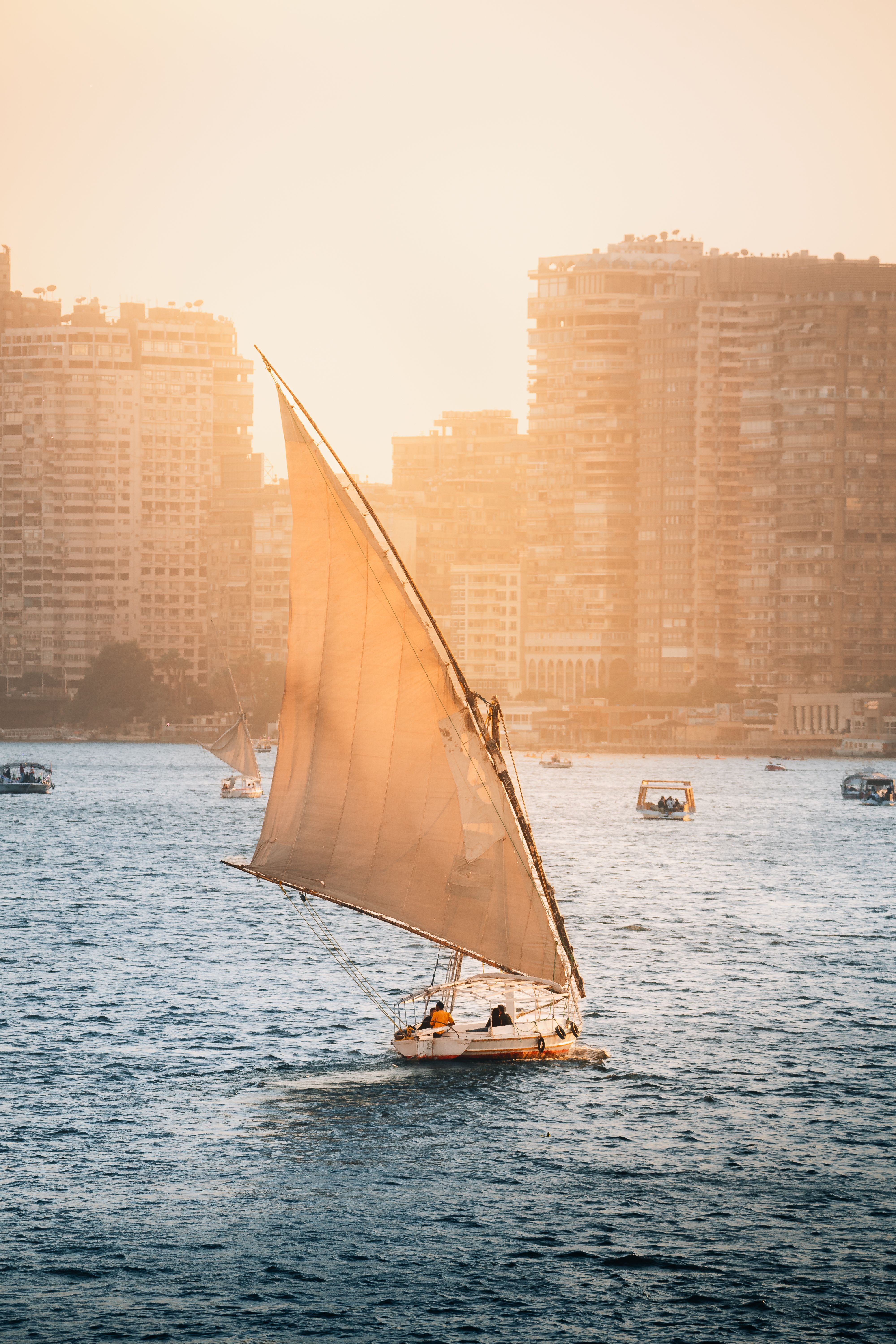 Traditional dahabiya sailing on the Nile at sunset