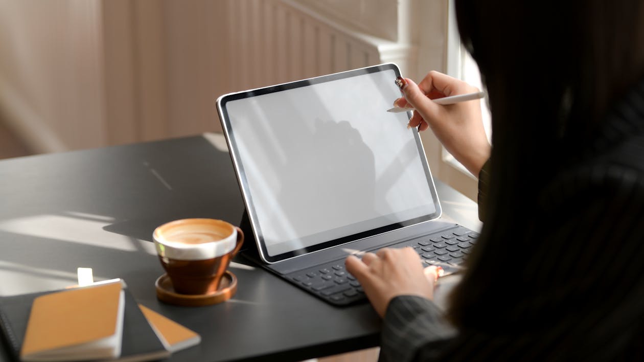 Person Using Tablet Computer With Keyboard