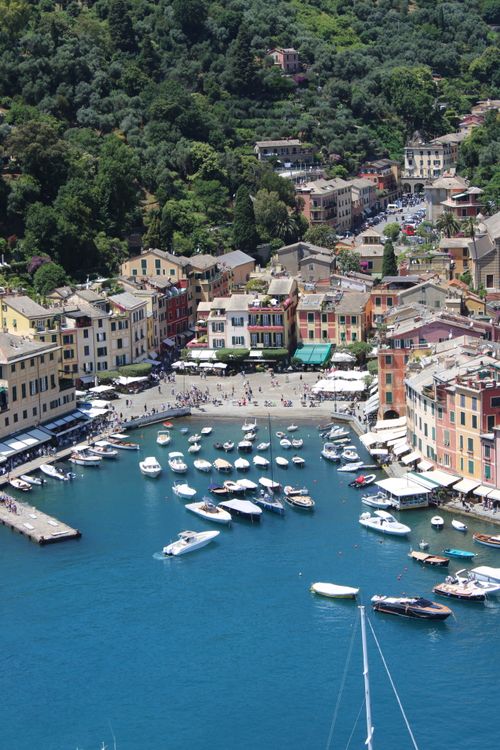 Free Aerial photo capturing the charming harbor of Portofino, Italy with vibrant buildings and docked boats. Stock Photo