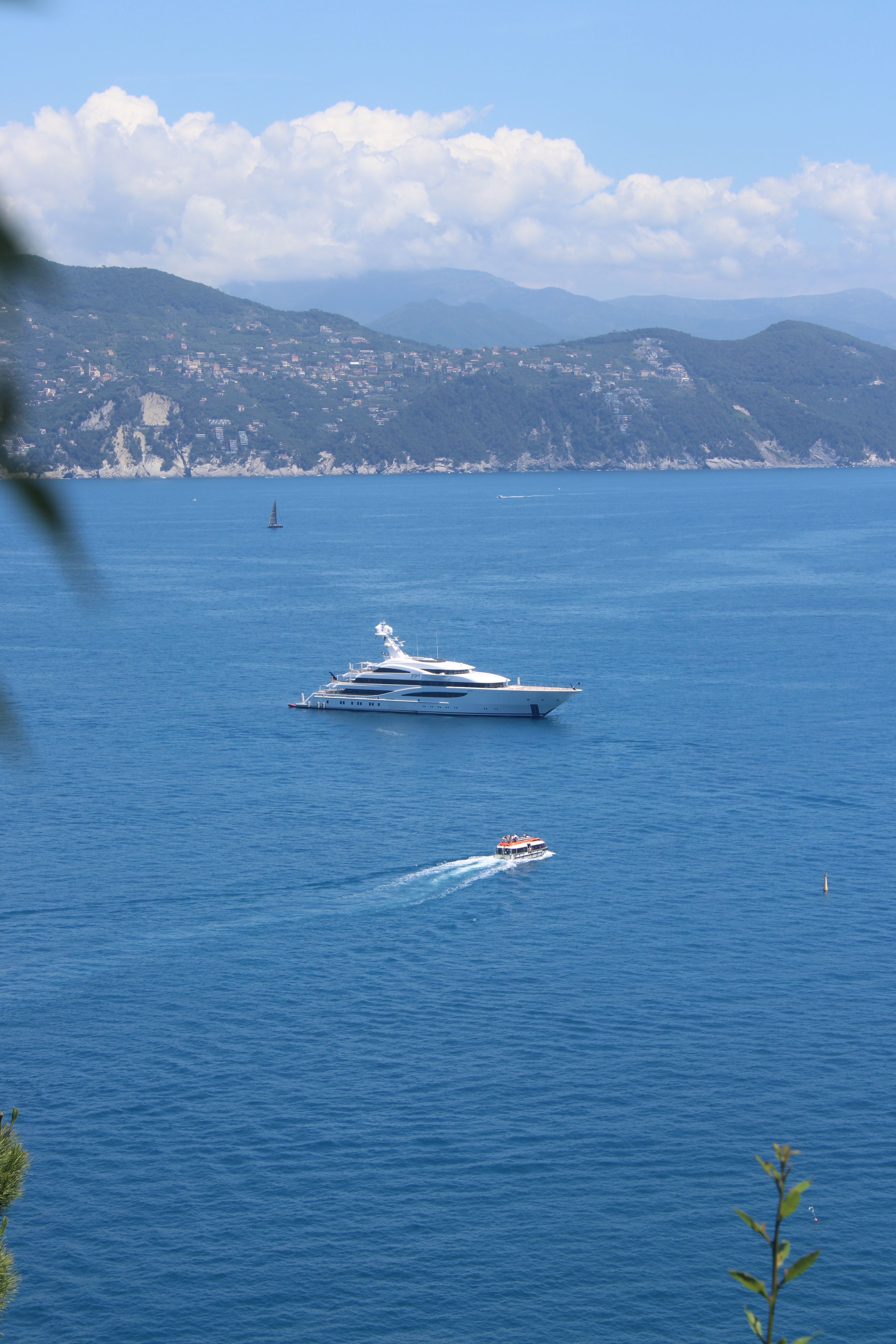 Luxury yachts anchored along the blue waters of the Ligurian coast near Portofino, Italy