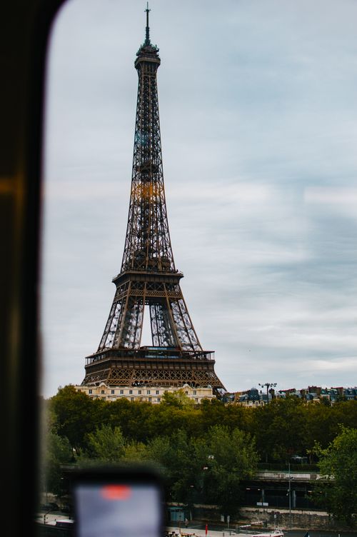 Free Captivating view of Eiffel Tower through a window in Paris, perfect for travel inspiration. Stock Photo