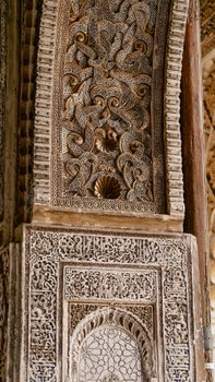 A detailed view of Mudejar architectural carvings from a historic building in Seville, Spain.
