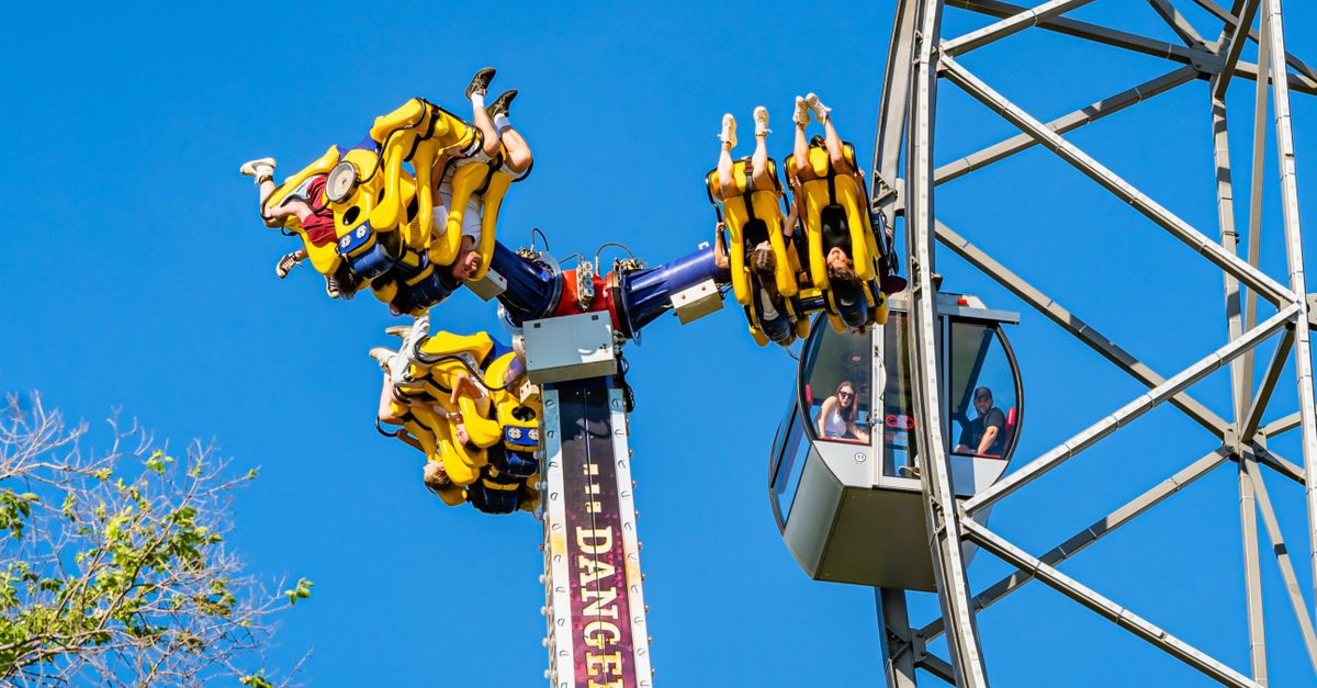 Adventurous ride on a thrilling roller coaster at a sunny amusement park.