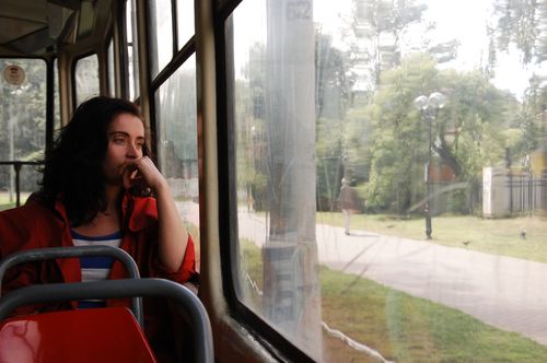 Free A thoughtful woman gazes out the window during a tram journey in Kaliningrad, Russia. Stock Photo