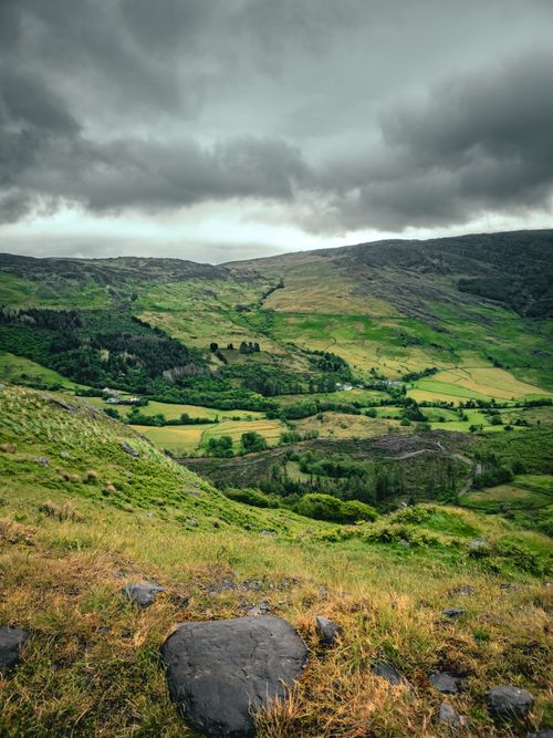 Free Lush green hills and dramatic clouds over the Irish countryside. Stock Photo