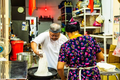 Free A chef and assistant making traditional Chinese noodles inside a kitchen setting. Stock Photo
