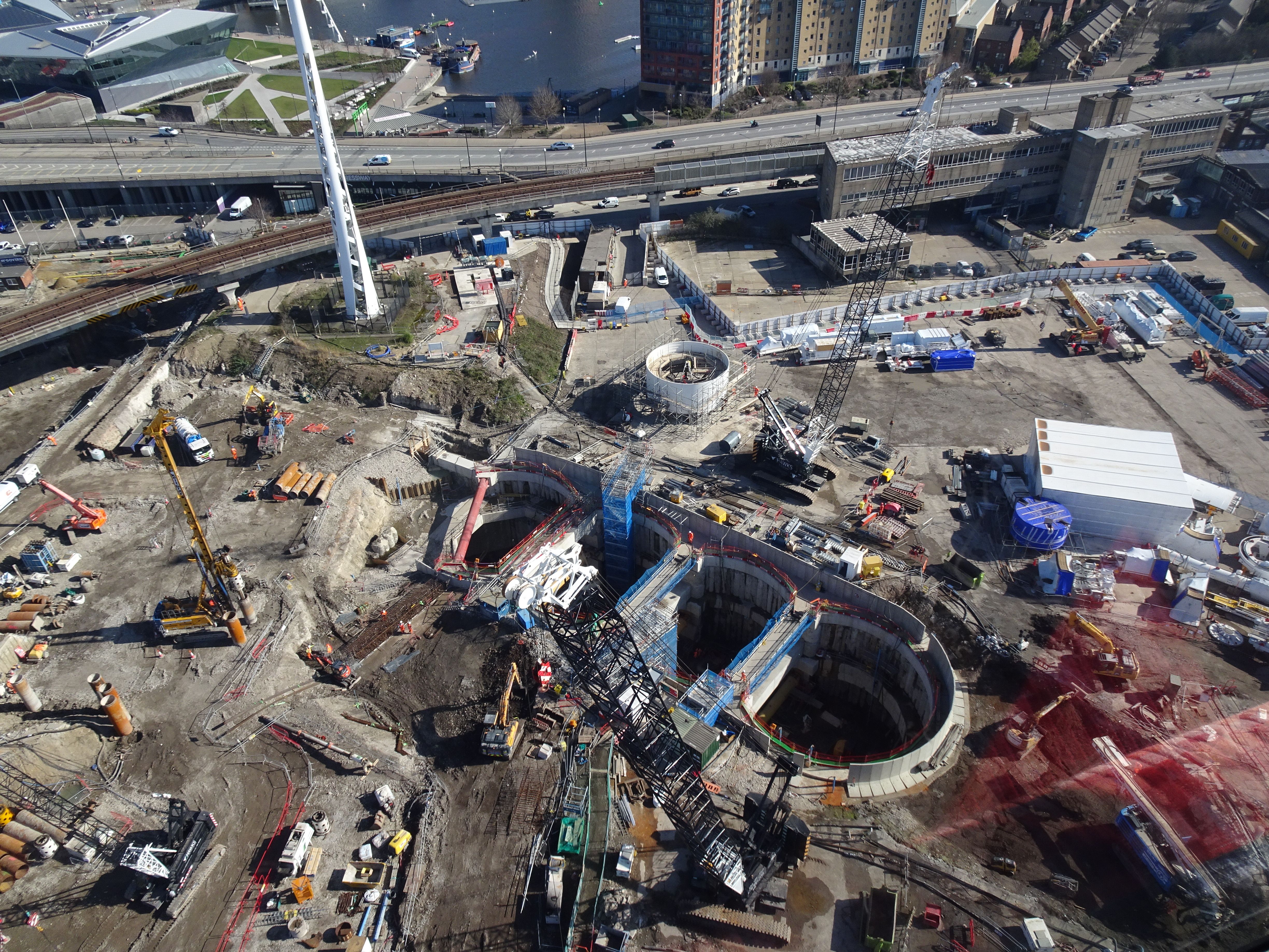 Aerial photograph of a bustling construction site in London, near the River Thames, showcasing industrial progress.