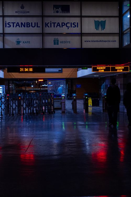 Free Night view of Istanbul ferry terminal with clock and reflections on wet floor. Stock Photo