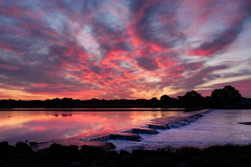 Free Breathtaking sunrise over Cove Island Park in Stamford, Connecticut, with vibrant pink and orange skies. Stock Photo