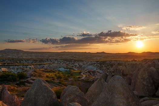 Golden hour over Göreme's unique rock formations in Cappadocia, showcasing stunning natural beauty.