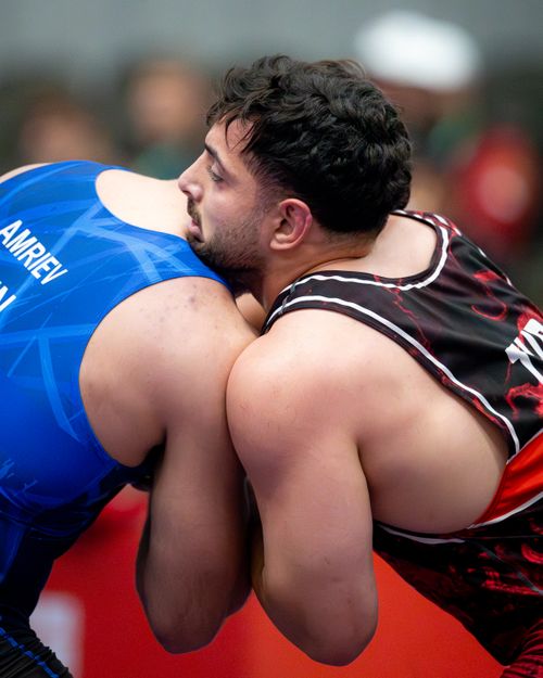 Free Two athletes in a close wrestling match showcasing strength and technique. Stock Photo