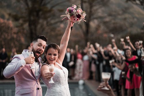 Shallow Focus Photo of Couple Smiling While Holding Wine Glass