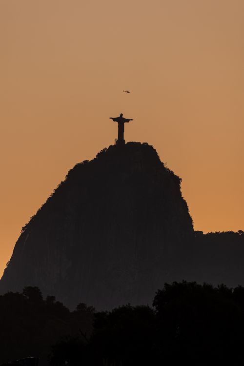 Free Silhouette of Christ the Redeemer statue against a stunning sunset in Rio de Janeiro. Stock Photo