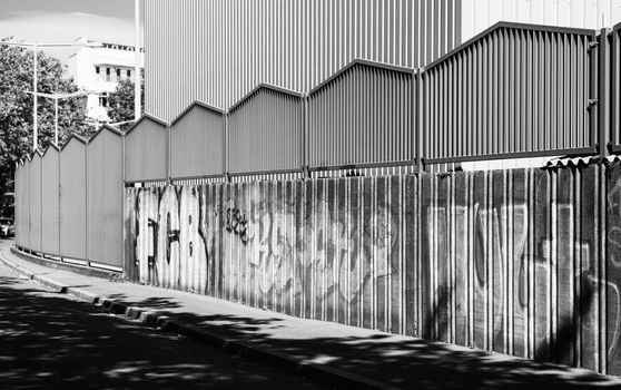 Black and white photo of a graffiti-covered wall in Basel, Switzerland, with architectural lines.