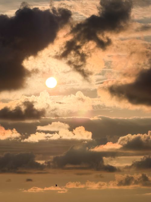 Free Stunning sky with dramatic clouds and the sun setting, creating a vivid natural spectacle. Stock Photo