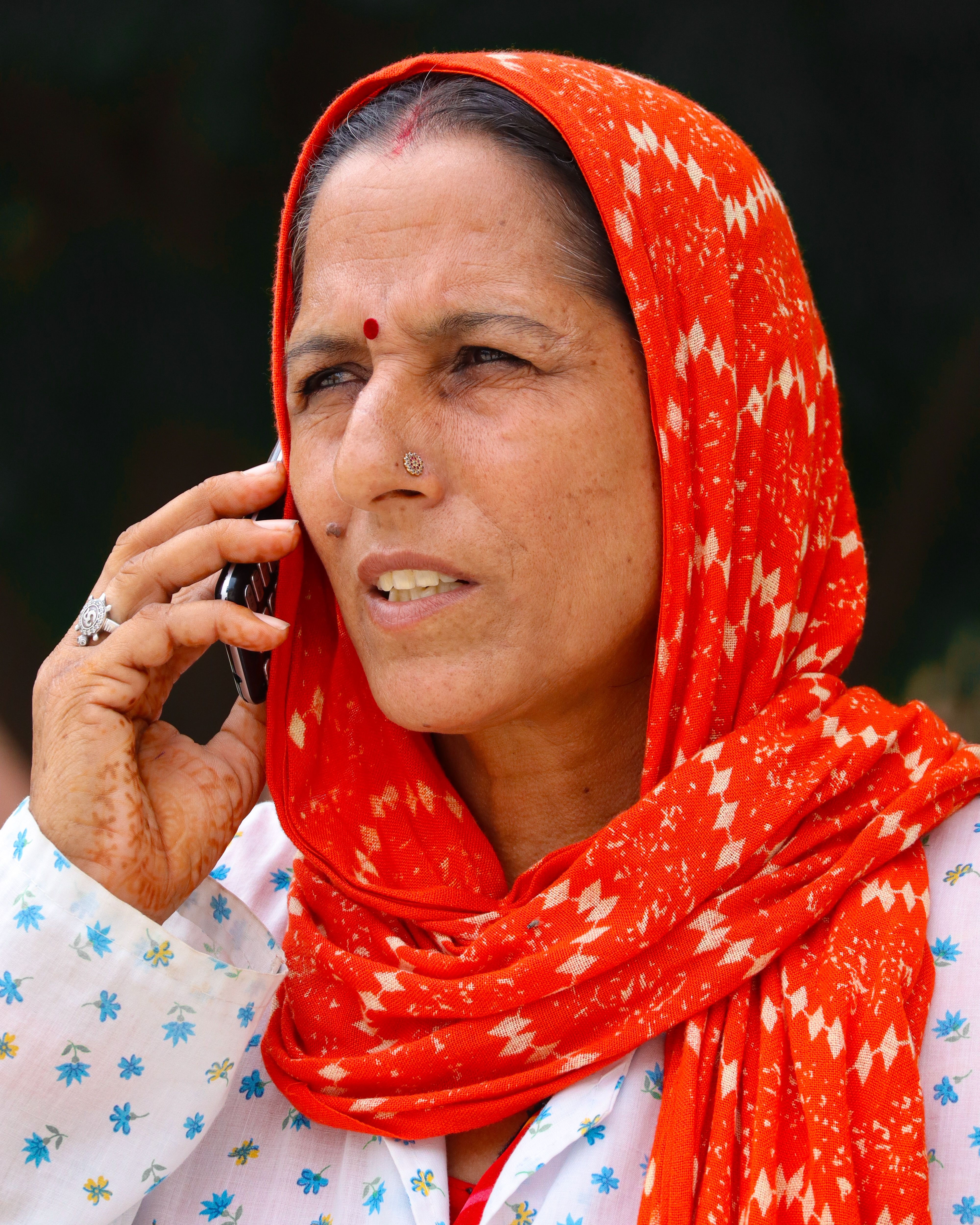 Woman in Traditional Attire on Phone · Free Stock Photo
