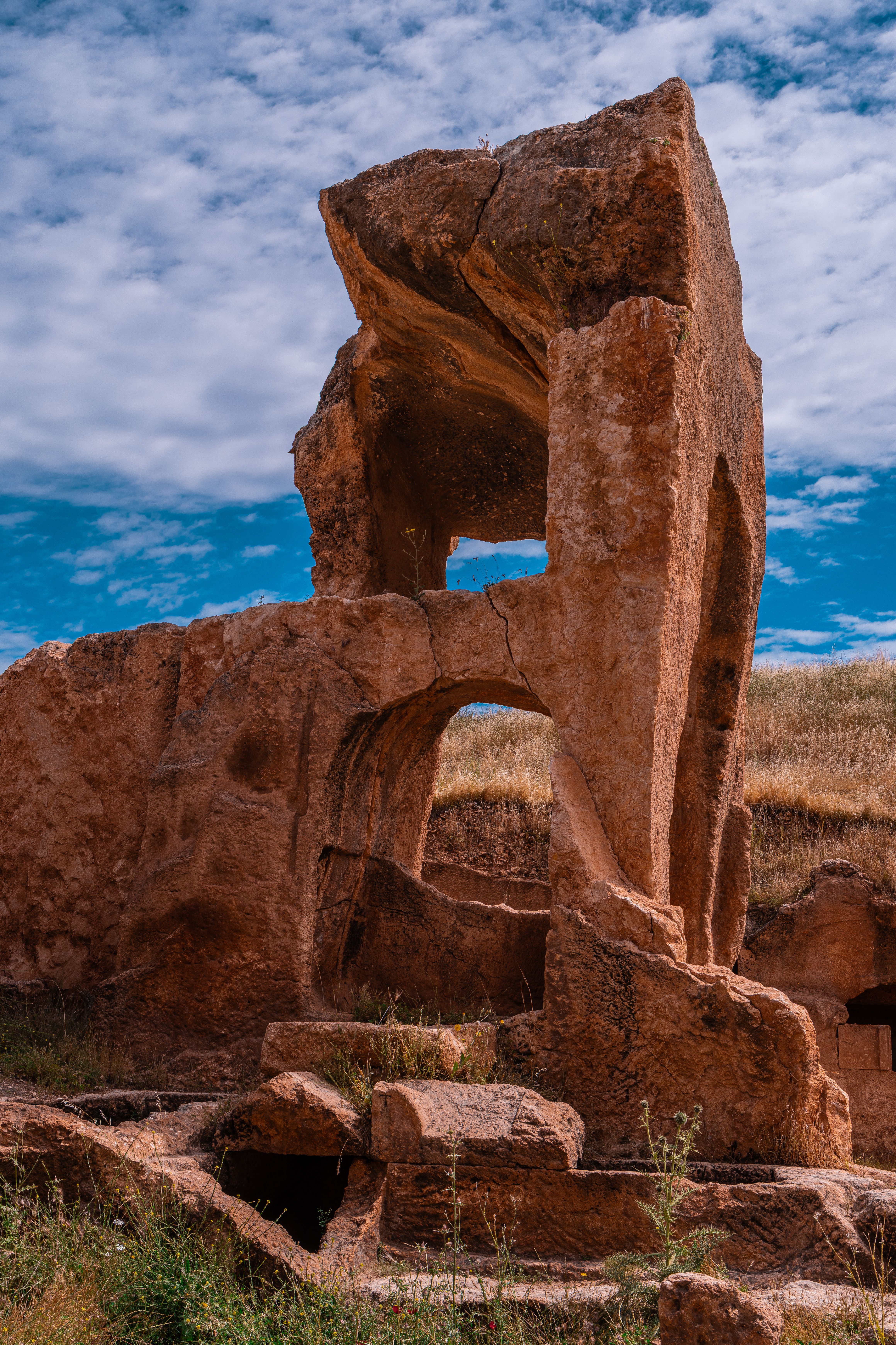 Captivating view of ancient stone ruins in Mardin, Türkiye under a vibrant blue sky.