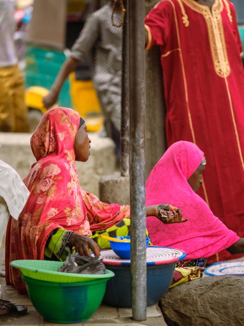 Free Vibrant street market in Zaria, Nigeria with women selling goods in colorful attire. Stock Photo