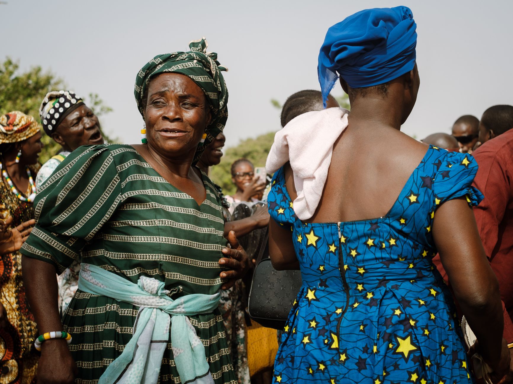 Colorful gathering in Nigeria showcasing traditional attire and joyful expressions.