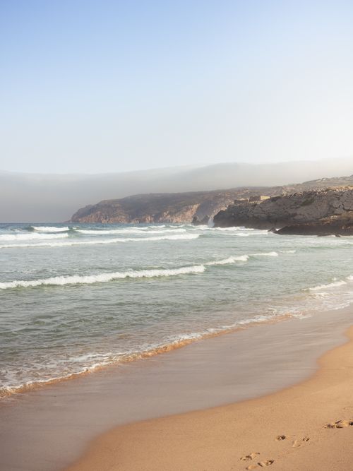 Free Tranquil beach with waves at Cabo da Roca, Sintra, Portugal. Stock Photo