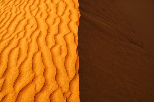 Striking image showing the contrasting textures and colors of sand dunes in the Sharjah desert.