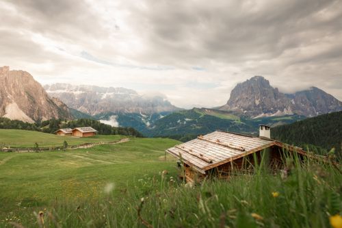 Free Picturesque alpine landscape with mountains and cabins in Trentino-Alto Adige, Italy. Stock Photo