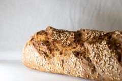 Freshly baked homemade bread loaf with sesame seeds, highlighting texture and crust.